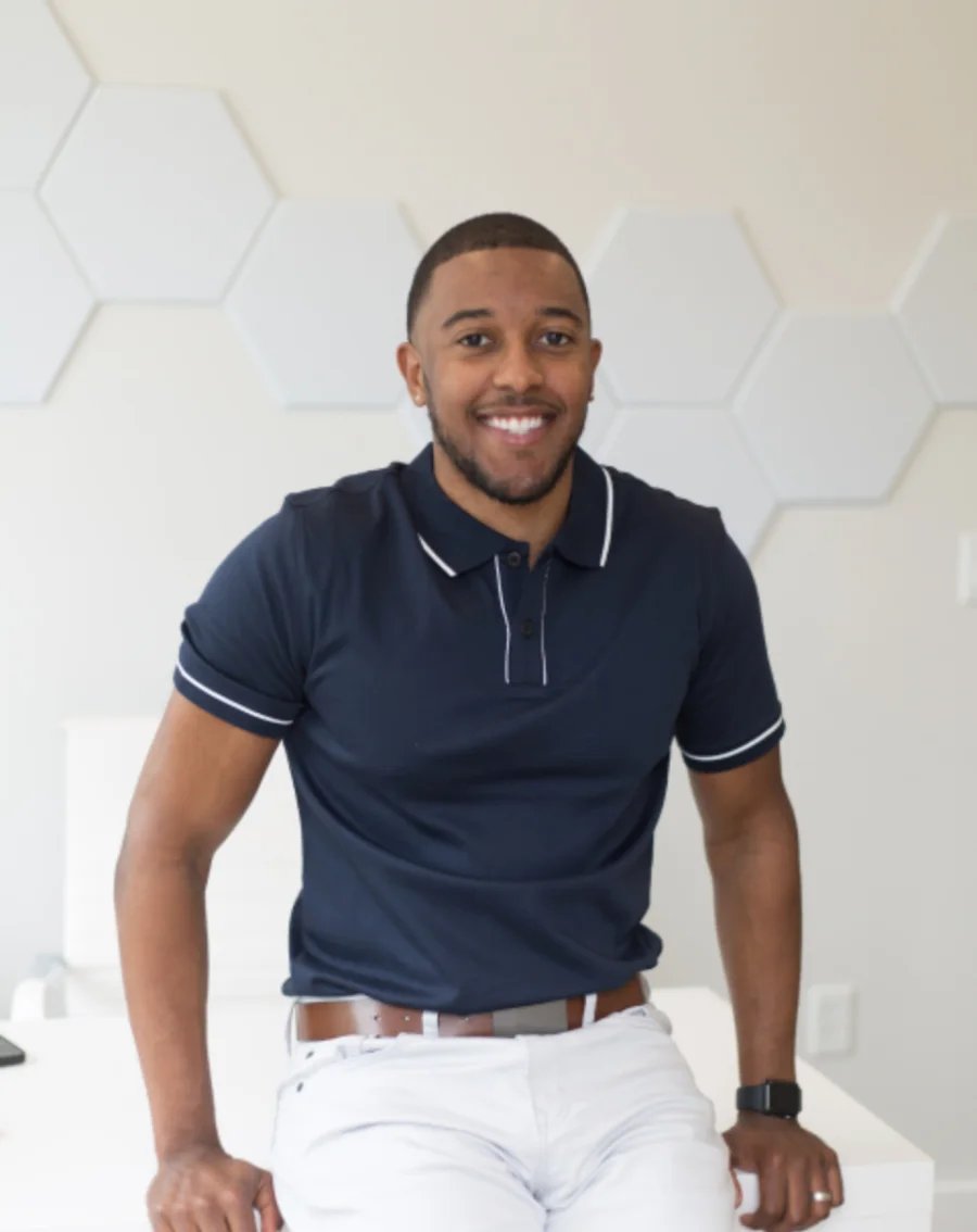August Reyes, art director, photographed against a plain patterned wall